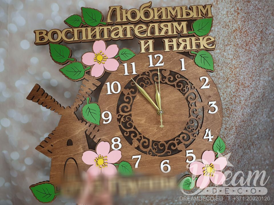 Pulkstenis ar vējdzirnavām, ziediem un lapām un uzrakstu - Любимым воспитателям и няне + paraksts no ka dāvināts (apakšā)